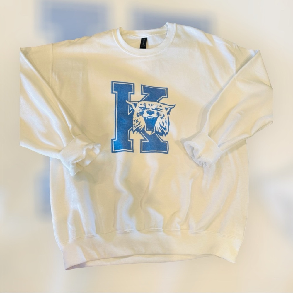 White Sweatshirt with Blue Wildcat Logo.